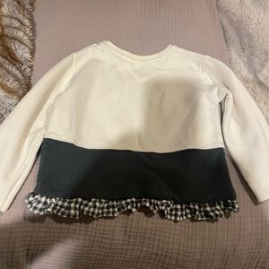 White sweatshirt with black checkered ruffles
